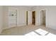 Cozy bedroom with plush carpeting, built-in shelving, and doorways leading to closets or other rooms at 25 Blackhorn Ct, Pittsboro, NC 27312