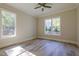 This bedroom features abundant natural light via dual windows and ceiling fan for comfort at 25 Blackhorn Ct, Pittsboro, NC 27312