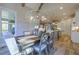 Dining room with natural light, modern light fixture, and view to kitchen at 25 Blackhorn Ct, Pittsboro, NC 27312