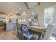 Dining room with natural light, modern light fixture, and view to kitchen at 25 Blackhorn Ct, Pittsboro, NC 27312