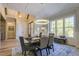 Elegant dining room with modern chandelier, wood table, and bright windows overlooking the outdoors at 25 Blackhorn Ct, Pittsboro, NC 27312
