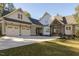 Charming two-story home with a two car garage, inviting entry, and manicured lawn at 25 Blackhorn Ct, Pittsboro, NC 27312