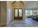 Elegant foyer boasting hardwood floors, a statement rug, and a glimpse into the dining room at 25 Blackhorn Ct, Pittsboro, NC 27312