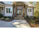 Inviting front entrance with wooden pillars, brick steps, and decorative pumpkins at 25 Blackhorn Ct, Pittsboro, NC 27312