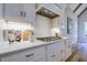 Bright kitchen with stainless steel range hood and a modern gas stovetop at 25 Blackhorn Ct, Pittsboro, NC 27312