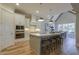 Modern kitchen with white cabinets, stainless steel appliances, island with seating and attached dining area at 25 Blackhorn Ct, Pittsboro, NC 27312