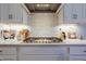 Bright kitchen with stainless steel range hood and a modern gas stovetop at 25 Blackhorn Ct, Pittsboro, NC 27312