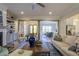 Open-concept view of the living room and dining area, featuring hardwood floors and natural light at 25 Blackhorn Ct, Pittsboro, NC 27312