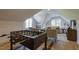 Beautifully designed living room with a foosball table, light hardwood flooring, and two large windows at 25 Blackhorn Ct, Pittsboro, NC 27312