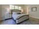 Comfortable main bedroom with large windows, wood floors, stylish furniture, and a relaxing ambiance at 25 Blackhorn Ct, Pittsboro, NC 27312