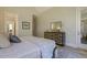 Spacious main bedroom with ample natural light, wood floors, a dresser, and access to the en suite bathroom at 25 Blackhorn Ct, Pittsboro, NC 27312