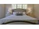 Elegant main bedroom with plush bedding, stylish nightstands, and large windows offering ample natural light at 25 Blackhorn Ct, Pittsboro, NC 27312