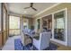Relaxing screened-in porch with wood floors, wooded views and a stylish rug creating a cozy atmosphere at 25 Blackhorn Ct, Pittsboro, NC 27312