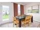 Stylish dining area with contemporary furniture, a large window, and elegant decor at 251 Perseus St, Angier, NC 27501