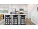 Modern kitchen features stainless steel appliances, granite countertops, and a central island with bar seating at 251 Perseus St, Angier, NC 27501
