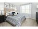 Bedroom featuring a bed with striped bedding, neutral walls, and natural light at 268 Grand Silo Rd, Raleigh, NC 27603