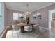 Beautifully staged dining room with mauve walls, modern chandelier, and coordinated décor at 3023 Whitfield Rd, Chapel Hill, NC 27514