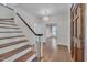 Welcoming foyer with hardwood floors, staircase, chandelier, and a wooden front door at 3023 Whitfield Rd, Chapel Hill, NC 27514