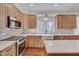 Spacious kitchen with quartz countertops, stainless appliances, and eat at island at 3023 Whitfield Rd, Chapel Hill, NC 27514