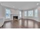 Spacious living room featuring a fireplace, hardwood floors, and many windows at 3023 Whitfield Rd, Chapel Hill, NC 27514