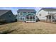 Backyard with a view of the home's blue siding and screened-in porch at 321 Price Lake Way, Fuquay Varina, NC 27526