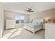 Bedroom with large window, ceiling fan and neutral colored walls and carpet at 321 Price Lake Way, Fuquay Varina, NC 27526