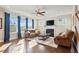 Cozy living room featuring a fireplace, hardwood floors, and ample natural light at 321 Price Lake Way, Fuquay Varina, NC 27526