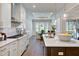 Contemporary kitchen open to dining area features quartz countertops and stainless appliances at 328 Conner Ridge Rd, Efland, NC 27243
