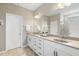Bathroom with double sink vanity, large mirror and white cabinets at 3333 Sandy Meadows Dr, Fuquay Varina, NC 27526