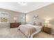 Cozy bedroom features a plush bed, dresser, and soft lighting from bedside lamps and windows at 3333 Sandy Meadows Dr, Fuquay Varina, NC 27526