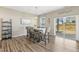 Dining room features a modern table with seating for six, with a sliding door offering outdoor access at 3333 Sandy Meadows Dr, Fuquay Varina, NC 27526