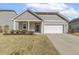Charming single-story home with gray siding, white trim, a manicured lawn, and an attached two-car garage at 3333 Sandy Meadows Dr, Fuquay Varina, NC 27526