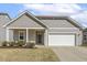 Charming single-story home with gray siding, white trim, a manicured lawn, and an attached two-car garage at 3333 Sandy Meadows Dr, Fuquay Varina, NC 27526