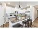 Modern kitchen island with granite countertops, barstool seating, and stainless steel appliances and white cabinetry at 3333 Sandy Meadows Dr, Fuquay Varina, NC 27526