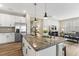 Spacious kitchen island with dark granite countertops, stainless steel appliances, and an open floor plan at 3333 Sandy Meadows Dr, Fuquay Varina, NC 27526
