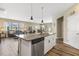 Open-concept kitchen island with bar seating and a seamless view into the living and dining areas at 3333 Sandy Meadows Dr, Fuquay Varina, NC 27526