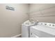 Bright laundry area featuring modern washer and dryer, storage shelf, and fun 'Wash & Dry' sign at 3333 Sandy Meadows Dr, Fuquay Varina, NC 27526