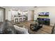 Spacious living area with modern furnishings, a large TV, and a view into the stylish kitchen at 3333 Sandy Meadows Dr, Fuquay Varina, NC 27526