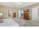 This is a bedroom with carpet and a television on top of a chest of drawers at 3333 Sandy Meadows Dr, Fuquay Varina, NC 27526