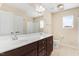 Bathroom featuring double sinks with chrome faucets, tan walls and tile floors at 346 Naples Ln, Clayton, NC 27527