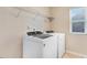 Functional laundry room with shelving, a washer, and a dryer at 346 Naples Ln, Clayton, NC 27527