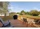 Wooden back deck features outdoor seating, a grill, and scenic backyard views at 3648 Praed Pl, Fuquay Varina, NC 27526