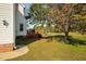 An inviting backyard features a wooden deck nestled under a mature tree, perfect for relaxation and outdoor enjoyment at 3648 Praed Pl, Fuquay Varina, NC 27526