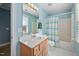 Inviting bathroom with a single vanity, large mirror and a shower/tub combo with colorful curtain at 3648 Praed Pl, Fuquay Varina, NC 27526