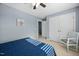 Serene bedroom with a blue accent wall, ceiling fan, carpet flooring, and a spacious closet at 3648 Praed Pl, Fuquay Varina, NC 27526