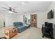 Spacious bonus room with neutral color and a comfortable blue sofa at 3648 Praed Pl, Fuquay Varina, NC 27526
