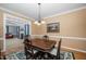 Formal dining room features wood table, chandelier, and connection to living room at 3648 Praed Pl, Fuquay Varina, NC 27526