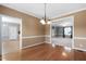 Dining room boasting hardwood floors, neutral wall color, and an open view into the living room at 3648 Praed Pl, Fuquay Varina, NC 27526