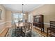 Well-lit dining room with a wooden table, hardwood floors, and a large window at 3648 Praed Pl, Fuquay Varina, NC 27526