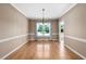 Bright dining room featuring hardwood floors, large window with natural light and neutral wall color at 3648 Praed Pl, Fuquay Varina, NC 27526